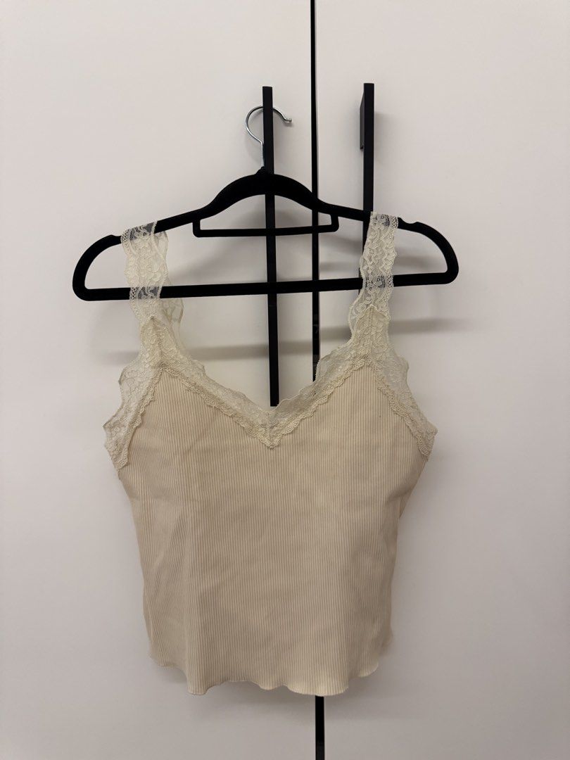 MNG Ribbed Tank Top with Lace (Category: Sleeveless) located in Manila. Submitted by sofffdlr (Listing ID 1434520721, Image 2). Description: - MNG tank top - Ribbed design - Lace detailing on straps and neckline - V-neck - Neutral color - Great for layering or wearing alone.