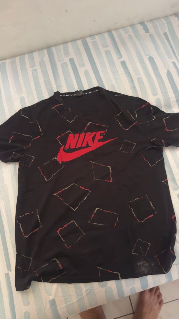 Nike Black Graphic T-shirt (Category: Tshirts & Polo Shirts ) located in Manila. Submitted by ryan.888 (Listing ID 1434432141, Image 1). Description: - Black Nike t-shirt - Red Nike logo - Repeating graphic pattern - Nike logo on neckline - Made of cotton - Standard fit - Size not specified.