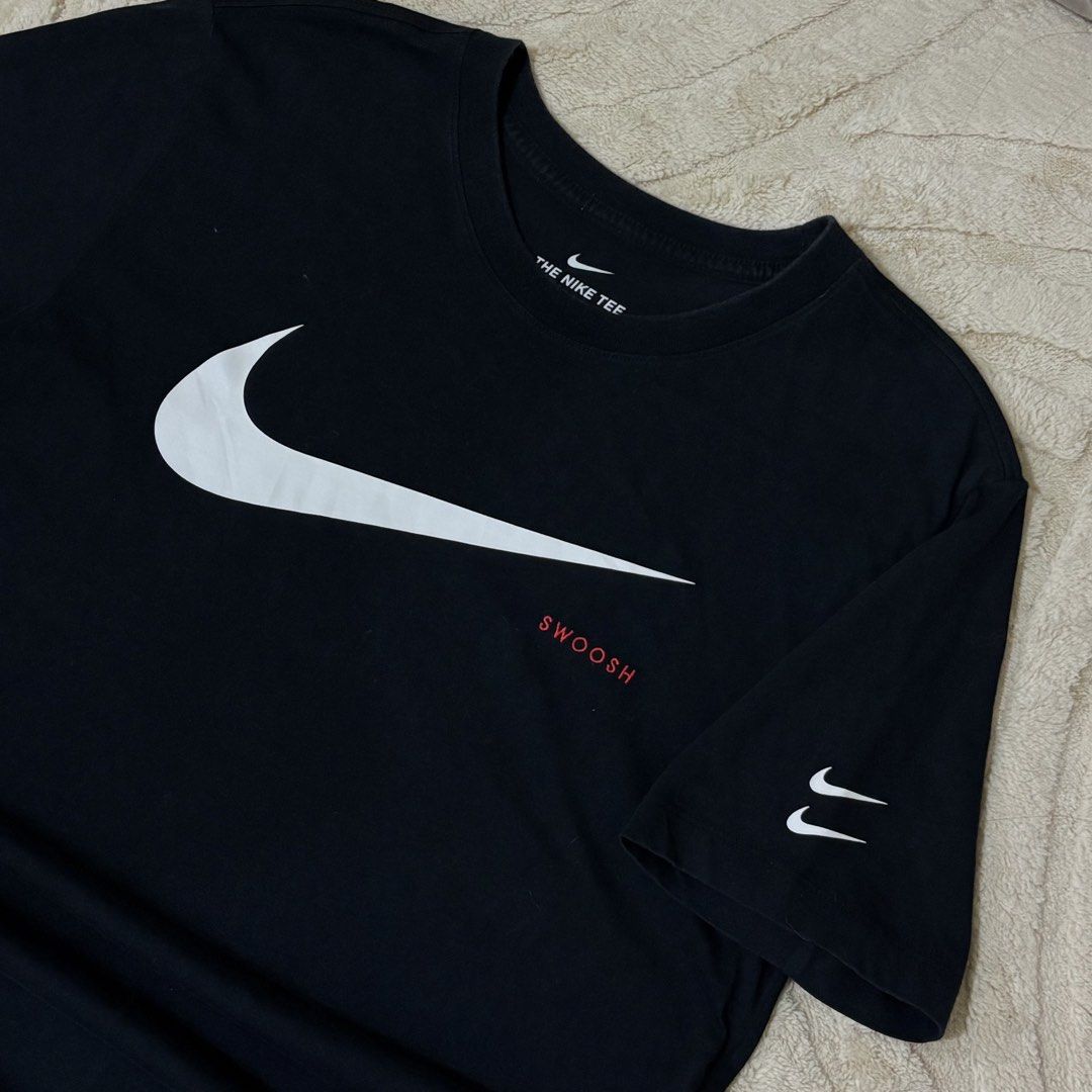 Nike Double Swoosh T-shirt (Category: Tshirts & Polo Shirts ) located in Quezon City. Submitted by grailph (Listing ID 1434558587, Image 1). Description: - Nike double swoosh t-shirt - Features a large white Swoosh logo on the front - Includes a smaller Swoosh on the sleeve - "SWOOSH" text in red below the logo - Size: Large on tag - 20” x 27” Dimension - Material: 100% cotton - Color rate 9/10 No issue.