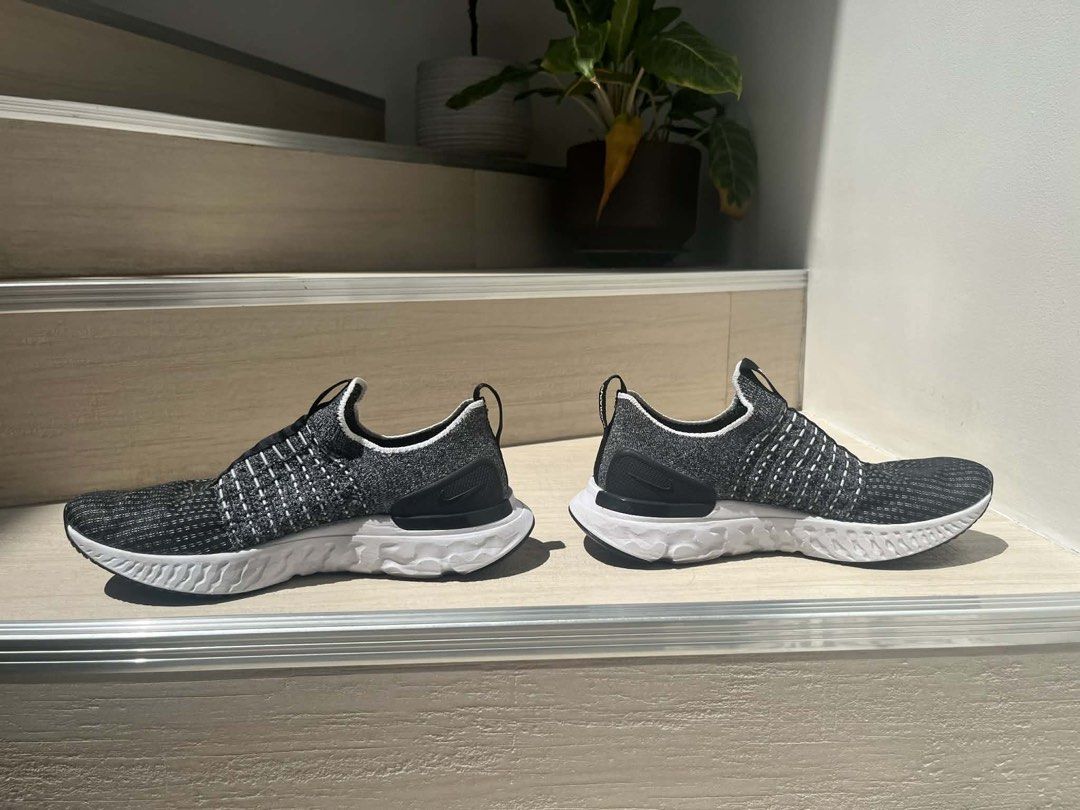 Nike React Phantom Run Flyknit 2 (Category: Sneakers) located in Quezon City. Submitted by arielleeet (Listing ID 1434403807, Image 2). Description: - Nike React Phantom Run Flyknit 2 - Slip-on design - Color: Black and White - Flyknit upper for a comfortable fit - White sole with black accents - Features a heel pull tab for easy wear - Nike logo branding.
