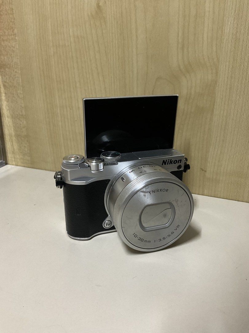 Nikon 1 J5 Mirrorless Camera (Category: Cameras) located in Quezon City. Submitted by guillic (Listing ID 1434494705, Image 1). Description: Nikon 1 J5 Mirrorless Camera - Has a flip screen, perfect for pictures and vlogging - Includes kit lens, extra lens, battery, charger, camera bag, and small tripod - Issues: has scratches, kit lens can’t be used to zoom in - Willing to send sample pics + videos - Price is still negotiable RFS: Need funds + I
