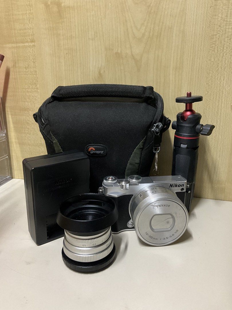Nikon 1 J5 Mirrorless Camera (Category: Cameras) located in Quezon City. Submitted by guillic (Listing ID 1434494705, Image 2). Description: Nikon 1 J5 Mirrorless Camera - Has a flip screen, perfect for pictures and vlogging - Includes kit lens, extra lens, battery, charger, camera bag, and small tripod - Issues: has scratches, kit lens can’t be used to zoom in - Willing to send sample pics + videos - Price is still negotiable RFS: Need funds + I