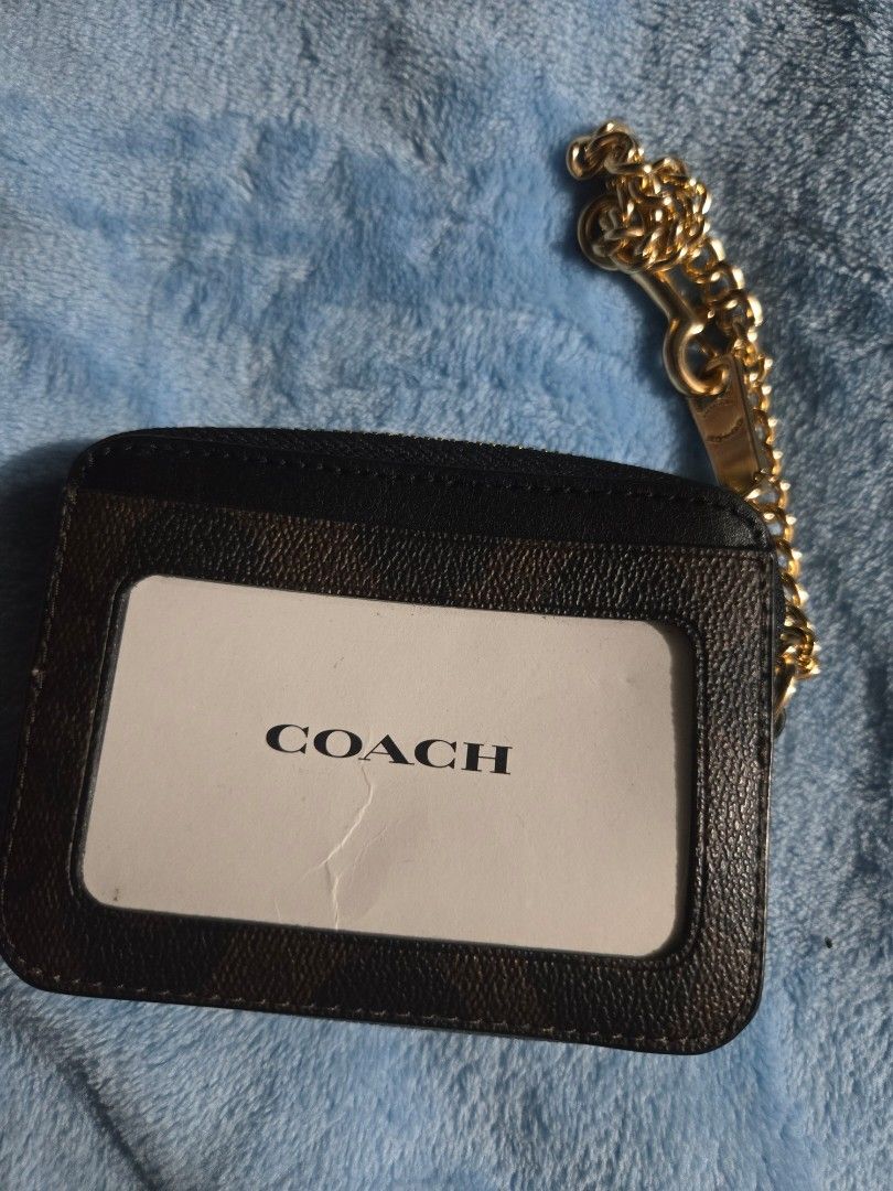 Original Coach Cardholder with Chain (Category: Luxury Bags & Wallets) located in Manila. Submitted by ms.rusell (Listing ID 1434538254, Image 2). Description: - Coach cardholder - Signature logo pattern - Includes a chain - Zippered compartment - Clear ID window - Color: Black and Brown - Condition: Good.