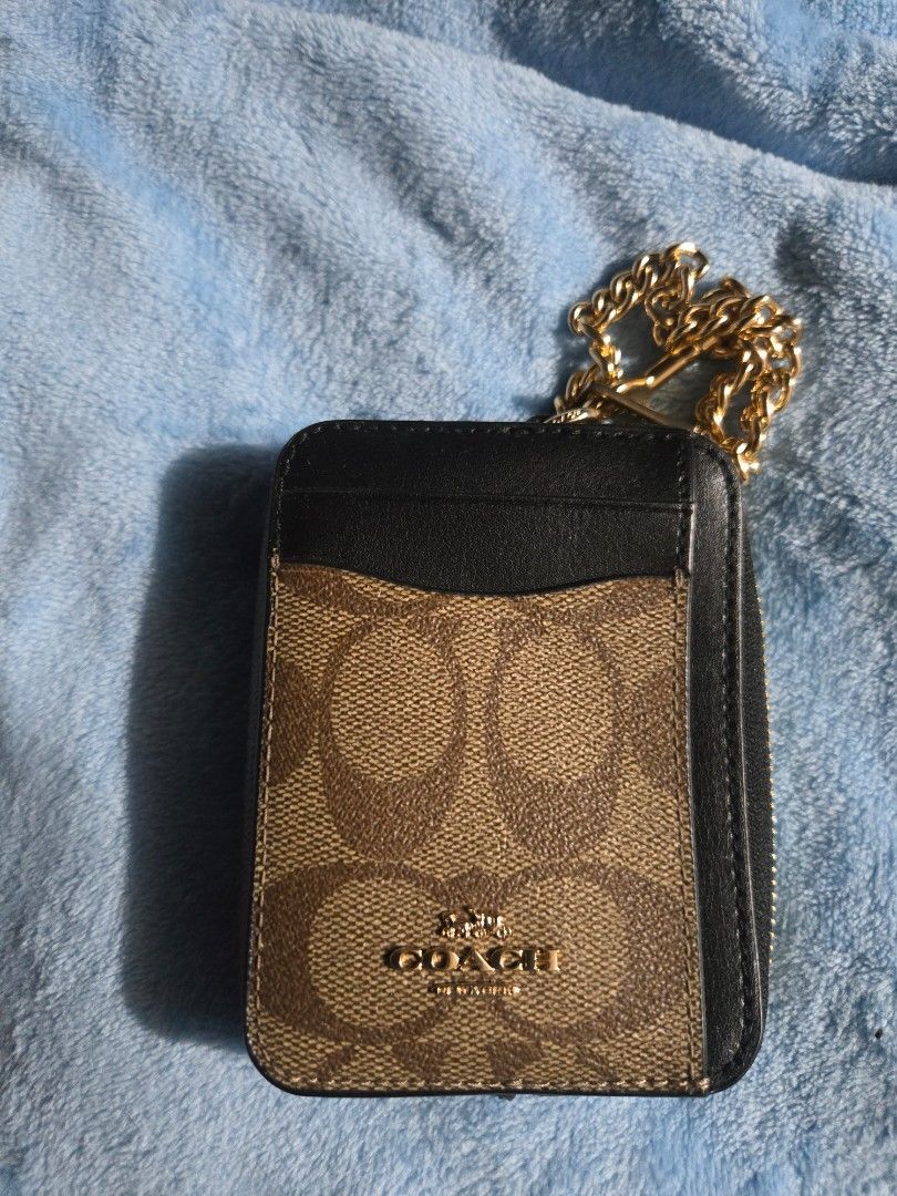 Original Coach Cardholder with Chain (Category: Luxury Bags & Wallets) located in Manila. Submitted by ms.rusell (Listing ID 1434538254, Image 1). Description: - Coach cardholder - Signature logo pattern - Includes a chain - Zippered compartment - Clear ID window - Color: Black and Brown - Condition: Good.