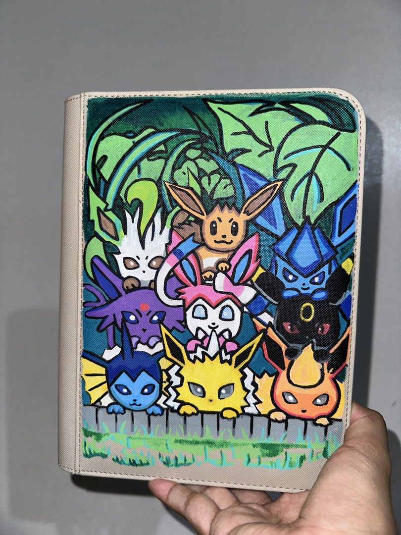 Pokemon TCG Custom Binders (Category: Trading Cards Accessories) located in Pasig City. Submitted by catwonieebuys (Listing ID 1434547693, Image 2). Description: - we customize 2x2 and 3x3 binders!! - hand painted designs (NOT PRINTED!!) - three premade design ready to use binders (eeveelutions 2x2, psyduck 2x2, & gengar 3x3) - base prices are: 2x2 size is ₱3500 and 3x3 size is ₱4500 - prices may still vary depending on the design, size, and bind