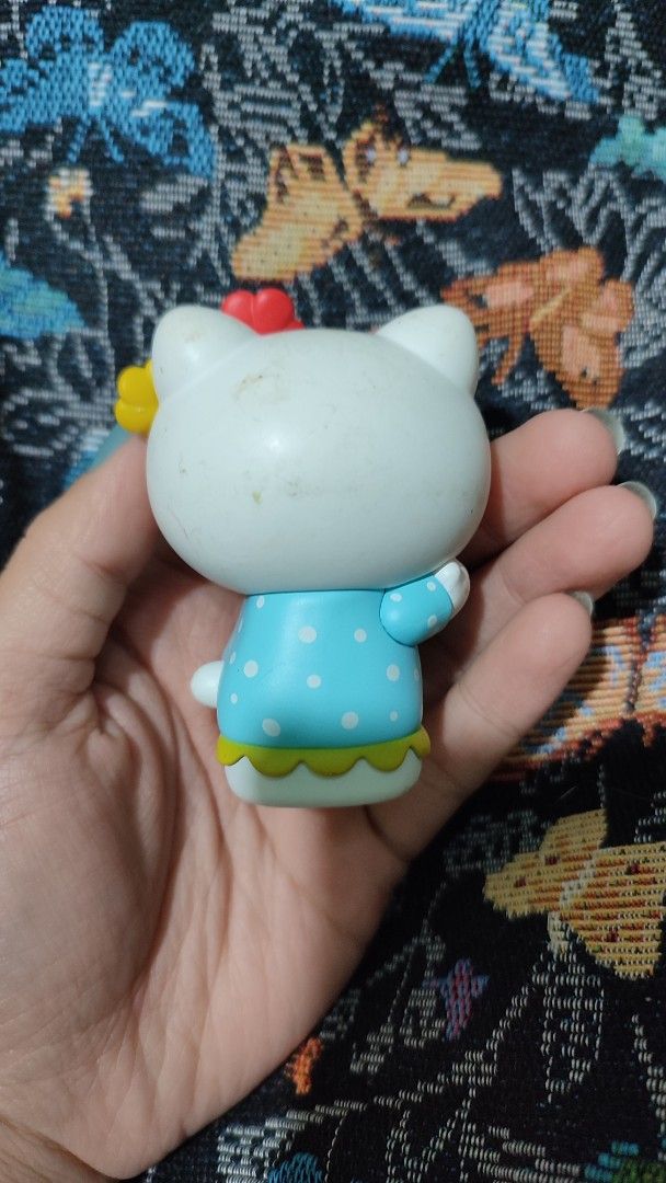 Pop Mart Hello Kitty 2021 Figurine (Category: Designer & Blind Box Toys) located in Baguio. Submitted by lynx_. (Listing ID 1434577921, Image 2). Description: - Pop Mart Kitty figurine - Released in 2021 - Features Kitty in a blue polka dot dress - Adorned with a floral headpiece - Yellow base - Includes Pop Mart and Sanrio branding.