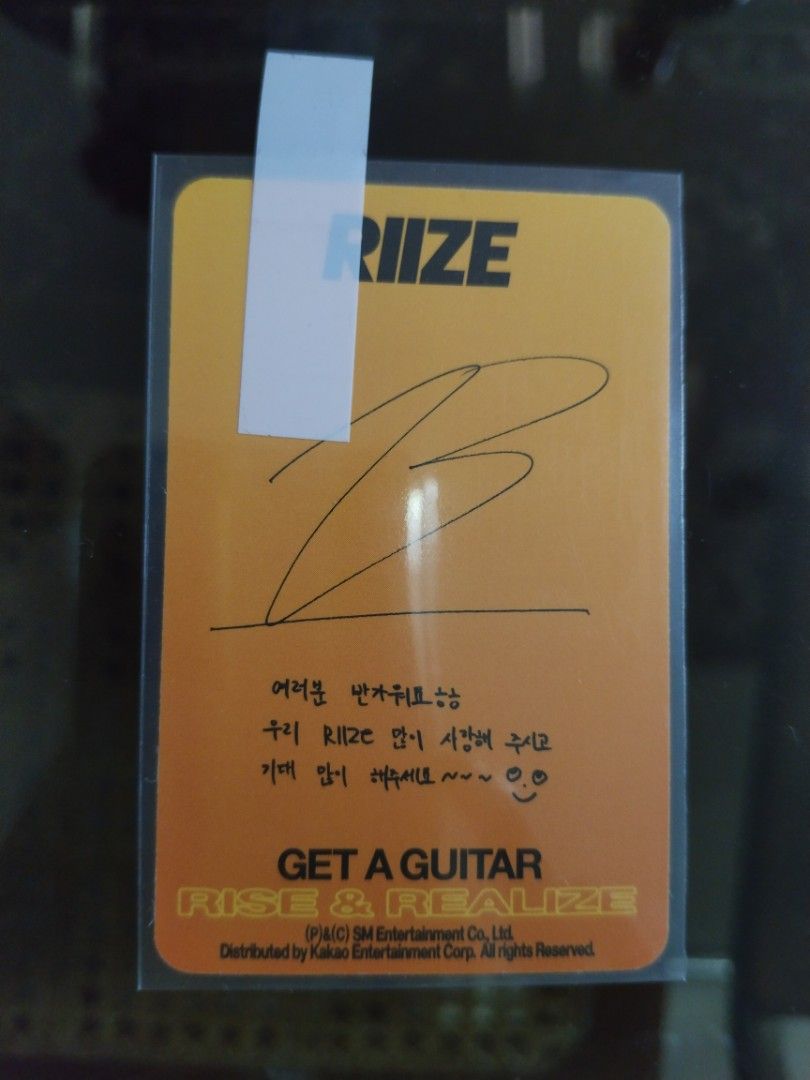 RIZE Get A Guitar Photocard (Category: Music Accessories) located in Manila. Submitted by tyrapple (Listing ID 1434449353, Image 2). Description: - RIZE Get A Guitar photocard - Features a member image - Includes protective sleeve - Back of card has RIZE logo and handwritten message - Distributed by Kakao Entertainment Corp..
