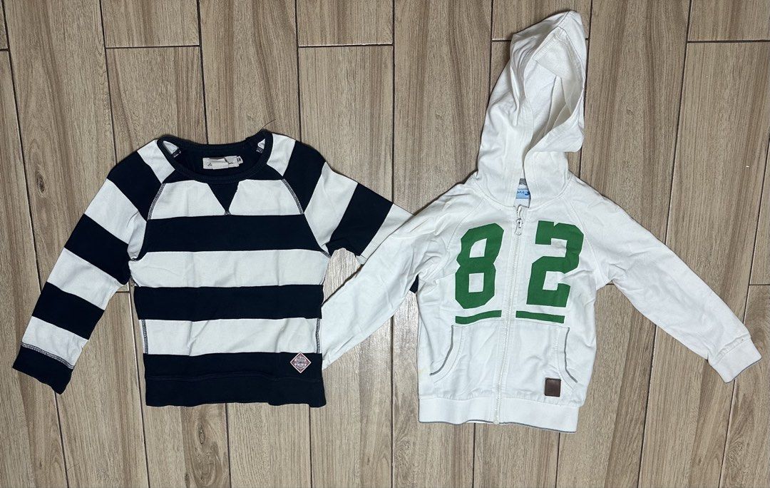 Striped Sweater and White Hoodie (Category: Babies & Kids Fashion) located in Manila. Submitted by sircee6 (Listing ID 1434518600, Image 1). Description: Listing includes a navy and white striped sweater and a white hoodie with the number 82 in green. The sweater has a crew neck and long sleeves. The hoodie has a zipper closure and a hood. Both items appear to be for a child..