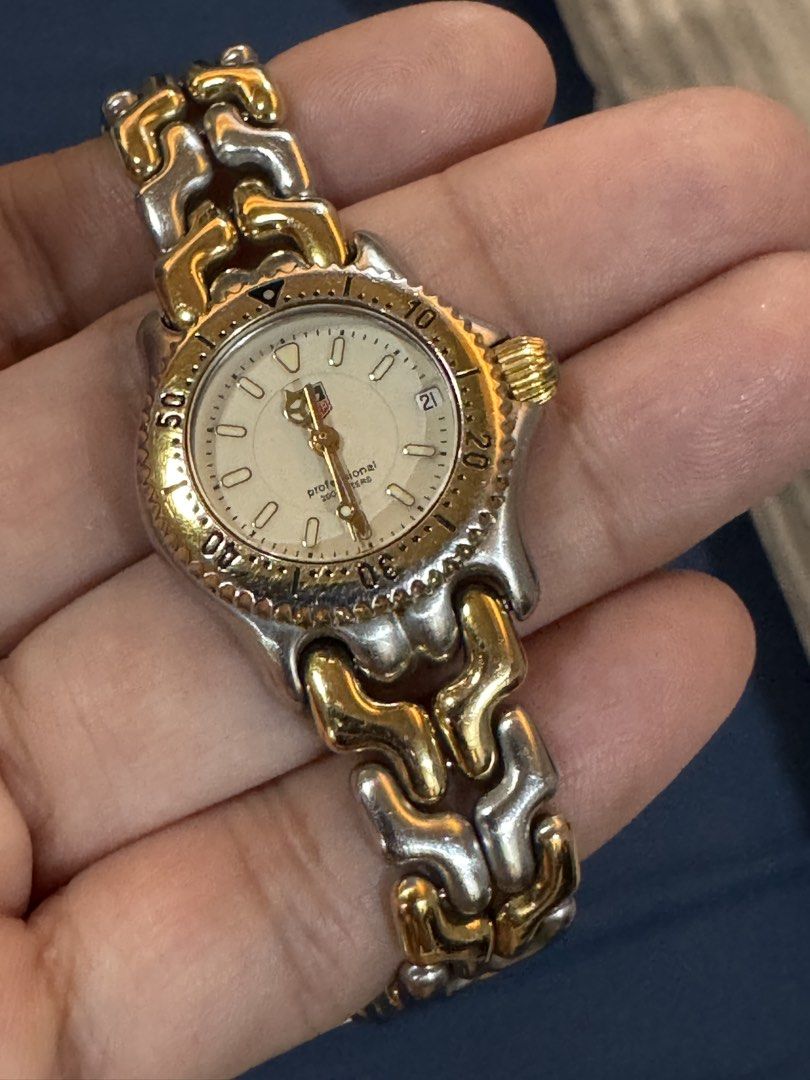 Tag Heuer Two Toned Ladies Watch (Category: Women's Watches) located in Taytay. Submitted by everythingonline888 (Listing ID 1434565137, Image 1). Description: - Tag Heuer Professional 200 Meters watch - Gold and silver-toned bracelet and bezel - White dial - Date display - Swiss made - Marked with "TAG HEUER" and "SWISS SINCE 1860" on the back No inclusions Signs of wear Slightly negotiable.