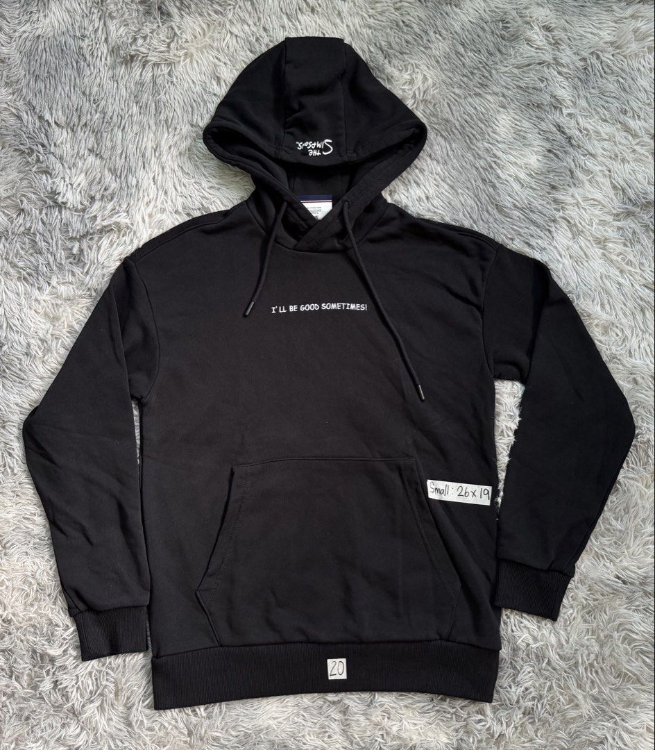 The Simpsons Ben Sherman Hoodie (Category: Coats, Jackets and Outerwear) located in Lila. Submitted by jkorapparel008 (Listing ID 1434544354, Image 1). Description: - Black hoodie with The Simpsons and Ben Sherman branding. - Features a front pocket and a hood with a drawstring. - Left sleeve: Spray paint can graphics. - Right sleeve: Target logo. - Back: Bart Simpson graphic with "EL BARTO WAS HERE" text. - Front: "I'LL BE GOOD SOMETIMES!" text.