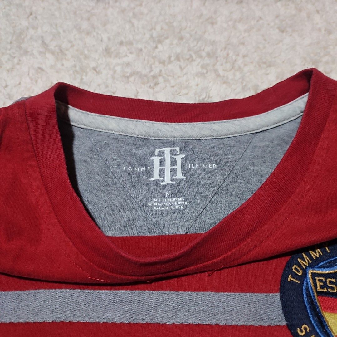 Tommy Hilfiger España Graphic Tee (Category: Tshirts & Polo Shirts ) located in Manila. Submitted by anthonig (Listing ID 1434471046, Image 2). Description: •Length: 27.5inches •Width: 21 inches •Condition: 9.5/10 •Issue: 3rd photo - Tommy Hilfiger t-shirt - Size: M - Design: Color block with 'España' across the front - Features: Crew neck, short sleeves - Details: Tommy Hilfiger logo patch with 'España' and Spanish flag.