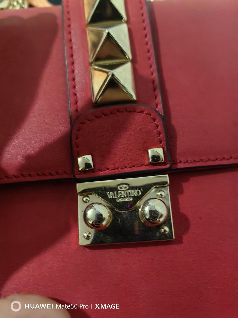 Valentino Garavani VItello Mini Glam Lock Rockstud Flap Red (Category: Luxury Bags & Wallets) located in Villasis. Submitted by mysticforest.bb2b4b (Listing ID 1434571299, Image 3). Description: - Red Valentino handbag - Gold-tone hardware - Chain strap - Studded flap closure - Interior zip pocket - Valentino label - Leather construction.