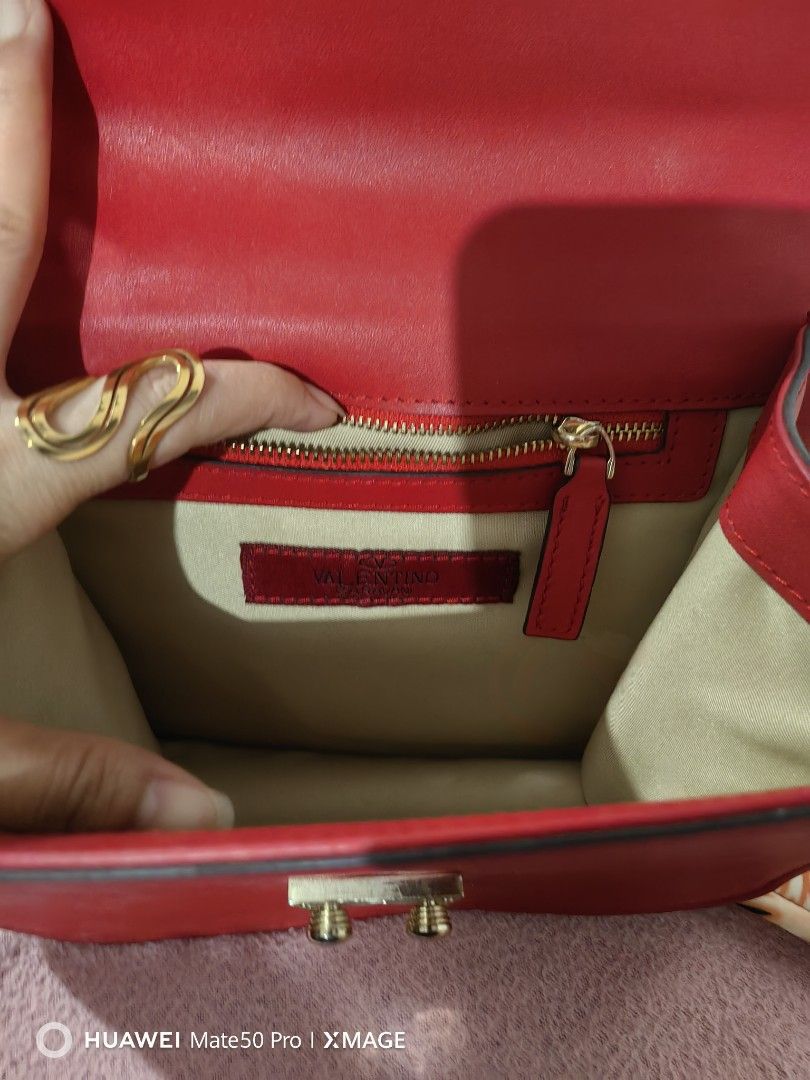 Valentino Garavani VItello Mini Glam Lock Rockstud Flap Red (Category: Luxury Bags & Wallets) located in Villasis. Submitted by mysticforest.bb2b4b (Listing ID 1434571299, Image 2). Description: - Red Valentino handbag - Gold-tone hardware - Chain strap - Studded flap closure - Interior zip pocket - Valentino label - Leather construction.