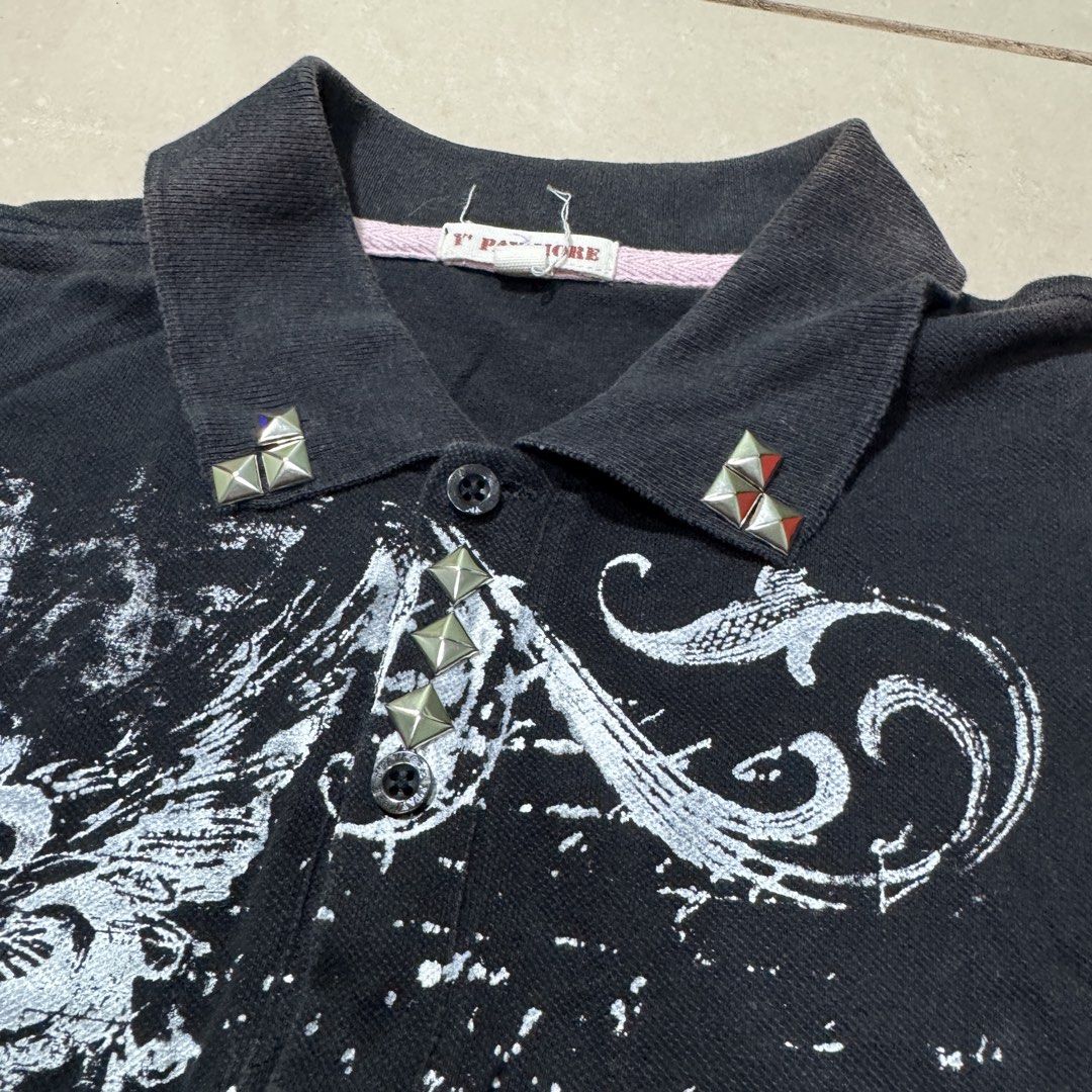 Y Panjore Black Polo Shirt with Studs (Category: Tshirts & Polo Shirts ) located in Valenzuela. Submitted by nijol (Listing ID 1434552598, Image 3). Description: - Y Panjore black polo shirt - Unique cross and wing graphic - Silver stud embellishments on collar and sleeves - Classic polo collar and short sleeves - Pink accent on the side.