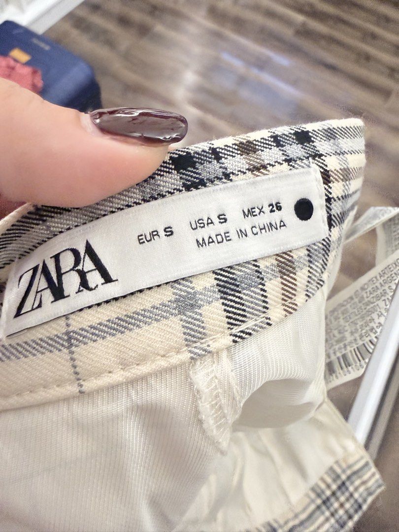 Zara Plaid Pleated Skirt (Category: Skirts) located in Quezon City. Submitted by joyandjoy (Listing ID 1434492990, Image 3). Description: - Zara plaid pleated skirt (Size S) - Classic plaid pattern: cream, black, and gray - Pleated design - Hidden zipper closure - Made in Mexico - Perfect for preppy or casual wear.