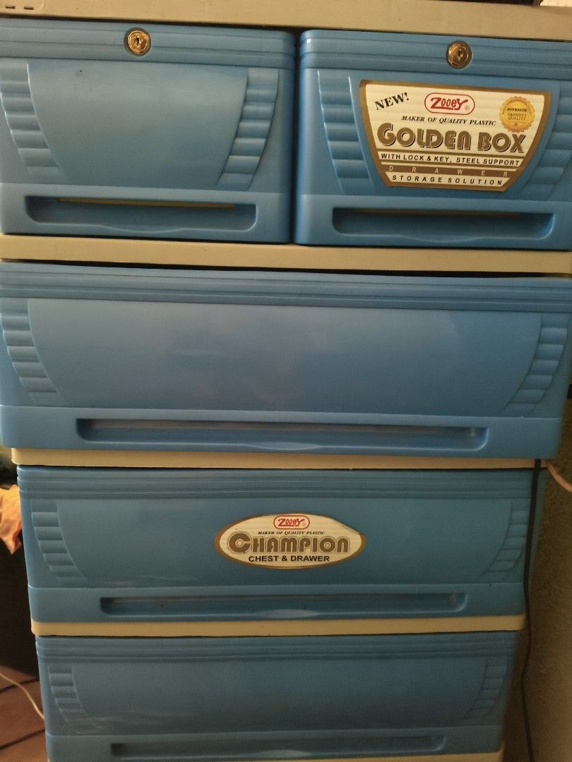 Zitty Golden Box Champion Chest & Drawer (Category: Shelves, Cabinets & Racks) located in Manila. Submitted by fiercedragon-6491 (Listing ID 1434446418, Image 1). Description: - Zitty Golden Box Champion chest and drawer. - Features multiple drawers for storage. - Color: Blue with beige trim. - Top drawer equipped with a lock. - Includes "Golden Box" and "Champion" labels. - Ideal for organizing various items..
