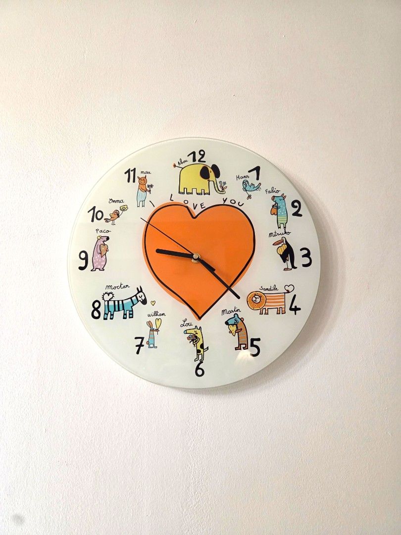 12" Glass Clock (Category: Clocks) located in Makati City. Submitted by shoppreloved_ (Listing ID 1434723347, Image 1). Description: Brand: Dimensione - Playful animal-themed wall glass clock - Features a charming design with an orange heart - Displays time with black hands - 12-inch size - Battery compartment at the back - Product details sticker included.