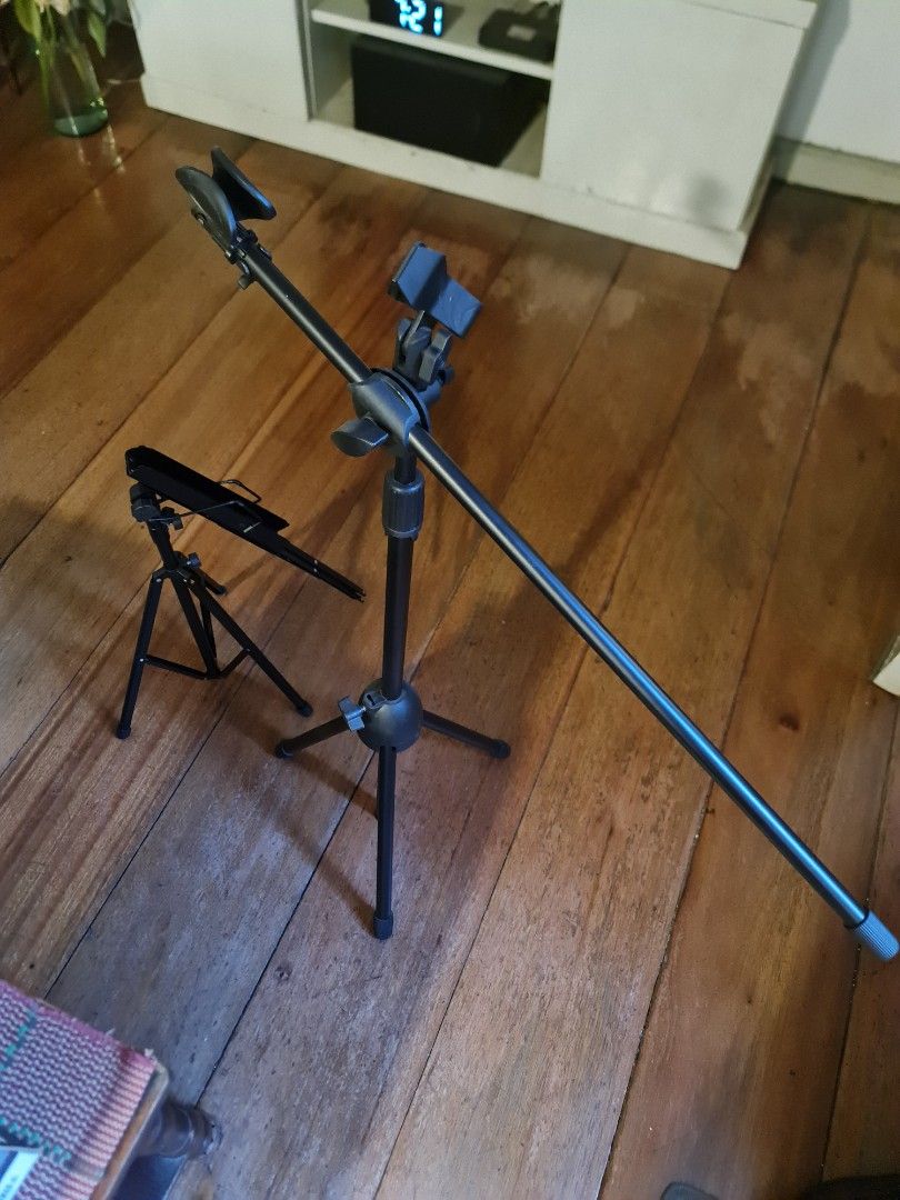 Adjustable Microphone Stand and lyrics stand (Category: Microphones) located in Mandaluyong City. Submitted by jldo28 (Listing ID 1434651426, Image 2). Description: - Adjustable microphone stand - Sturdy tripod base for stability - Adjustable arm for optimal microphone positioning - Includes a smaller stand - Suitable for various recording and performance setups - Durable black metal finish.
