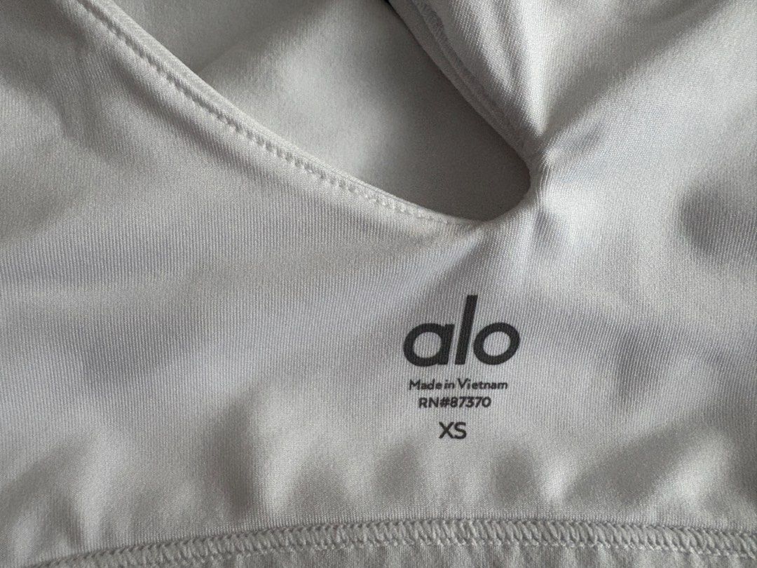 Alo Yoga White Cutout Sports Bra XS (Category: Activewear) located in Singapore. Submitted by bunnbunn5566 (Listing ID 1434714429, Image 3). Description: - Alo Yoga sports bra - White color - Size: XS - Unique cutout design - Ideal for yoga, pilates, and workouts.