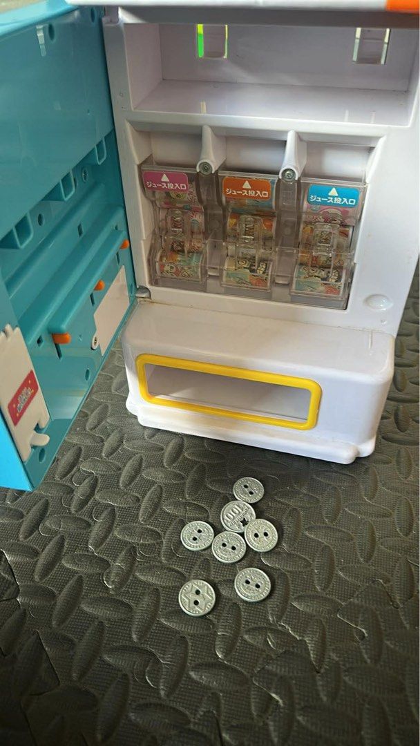 Anpanman Juice Vending Machine Toy (Category: Designer & Blind Box Toys) located in Cainta. Submitted by shopbyyna (Listing ID 1434743476, Image 2). Description: - Anpanman-themed juice vending machine toy. - Includes toy juice cups and play coins. - Features a clear top section for juice display. - Has a coin slot and dispensing area. - Made by JoyPalette. - Made in China..