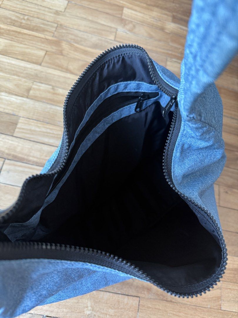 Baggu Nylon Shoulder Bag (Category: Shoulder Bags) located in Makati City. Submitted by clothesilovedx (Listing ID 1434613256, Image 3). Description: - Light blue denim-like material - Zip closure - Interior pocket - Machine washable Dimensions: 27.5" adjustable quilted strap 10.5" H x 14" W x 4" L.