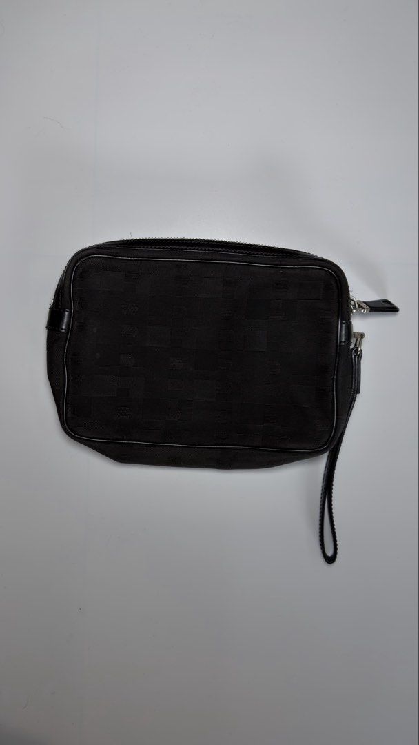 Bally Black Clutch Bag (Category: Luxury Bags & Wallets) located in Alfonso. Submitted by jbcamet (Listing ID 1434732916, Image 1). Description: Black clutch bag by Bally. Features a zip closure and a wrist strap. The interior includes a small pocket and a brand label. The bag is made in Spain. The exterior has a subtle pattern. The zipper has a Bally logo on the pull..