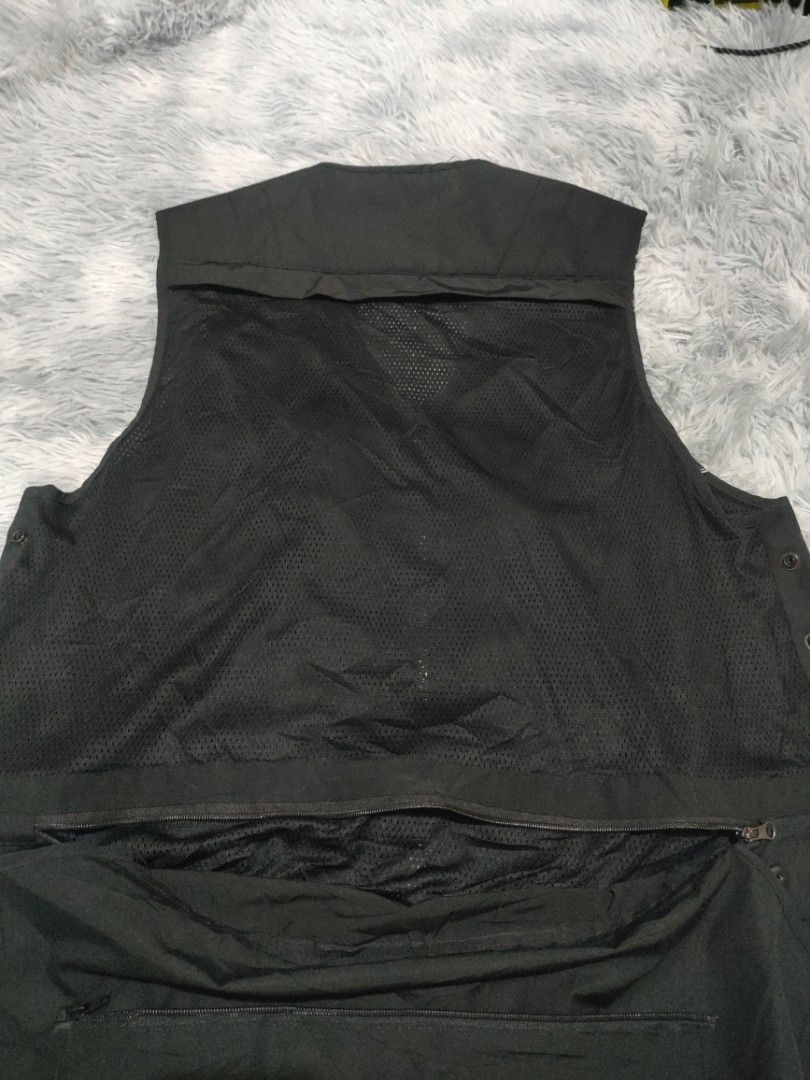 Black Tactical Vest with Multiple Pockets (Category: Vests) located in Toledo. Submitted by silverearth.bbc804 (Listing ID 1434621184, Image 3). Description: - Black tactical vest - Multiple pockets for storage - Zipper closure and adjustable buckles for a secure fit - Front pockets with flap closures - Mesh back panel for ventilation - Large zippered pocket on the back - Additional pockets on the front - Sleeveless design.
