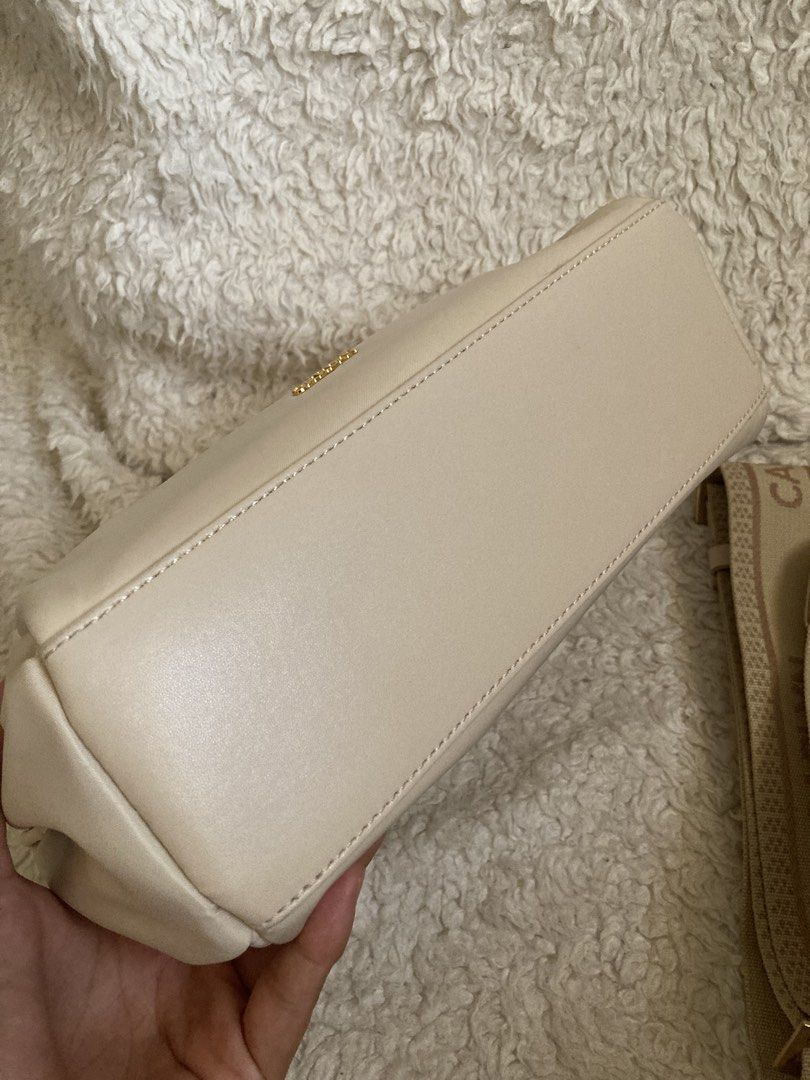 Carlyn Draw - Nylon crossbody (Ivory) (Category: Cross-body Bags) located in Mabalacat. Submitted by bagstrend (Listing ID 1434609163, Image 2). Description: Minimal dirt near zipper line and side garters of the outer pocket Dimension: 9.5" L x 7" H Color: Ivory Very good condition No COD, payment via gcash or bpi bank transfer. Price + sf Courier: JRS express / LBC No reservations. Pay today, ship tomorrow. No ship out on Sundays. Preloved, plea