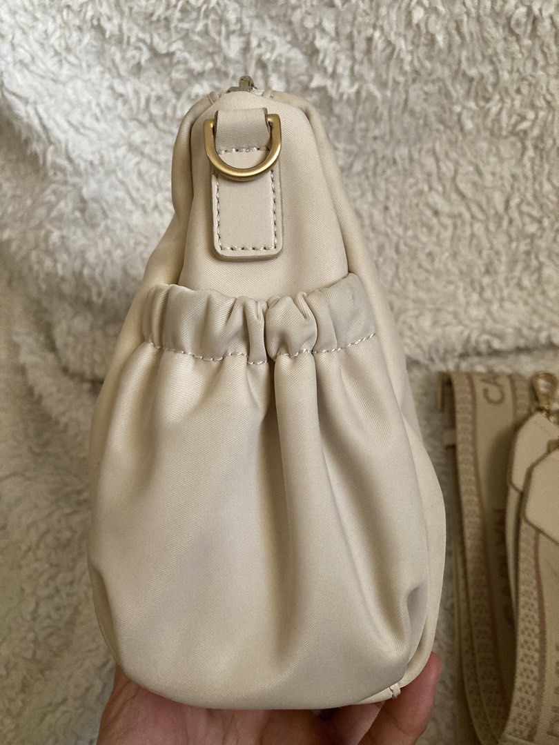 Carlyn Draw - Nylon crossbody (Ivory) (Category: Cross-body Bags) located in Mabalacat. Submitted by bagstrend (Listing ID 1434609163, Image 3). Description: Minimal dirt near zipper line and side garters of the outer pocket Dimension: 9.5" L x 7" H Color: Ivory Very good condition No COD, payment via gcash or bpi bank transfer. Price + sf Courier: JRS express / LBC No reservations. Pay today, ship tomorrow. No ship out on Sundays. Preloved, plea