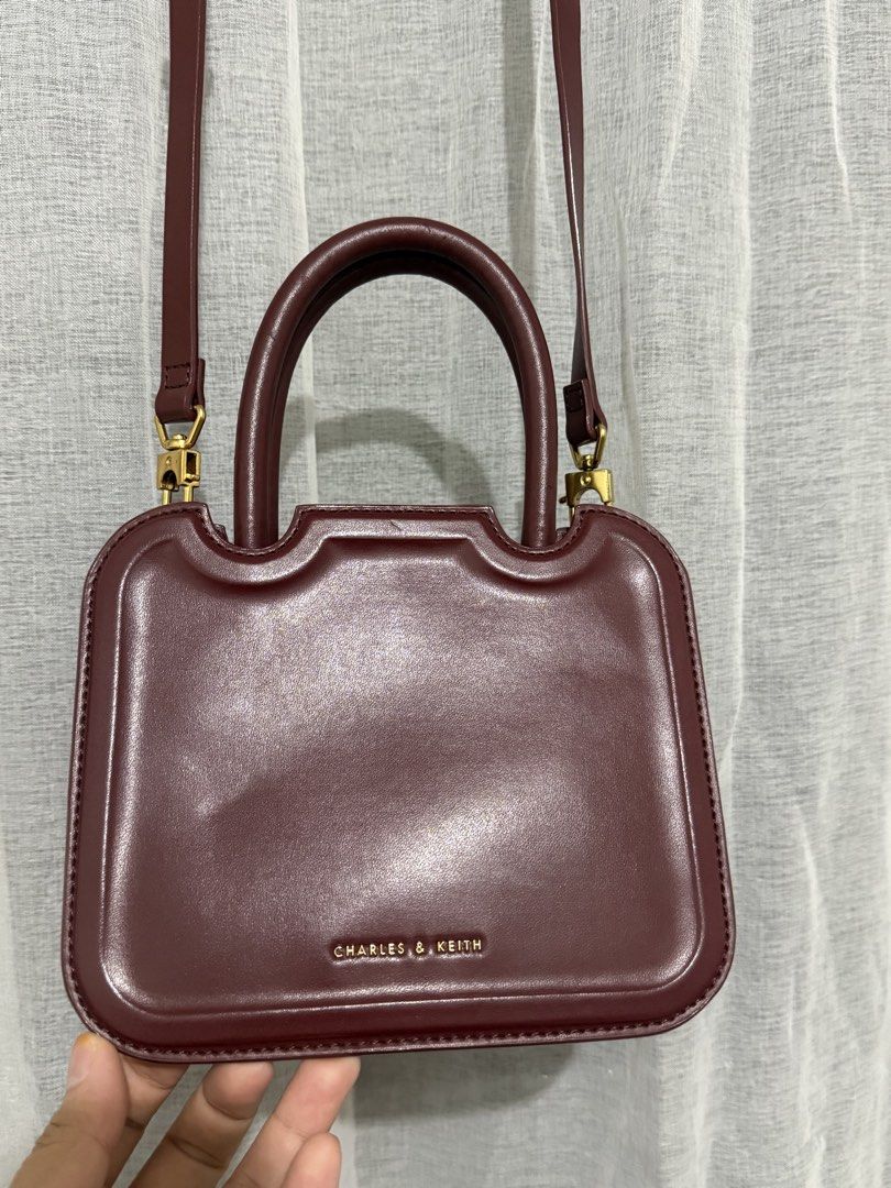 CHARLES & KEITH BURGUNDY SLING BAG (Category: Luxury Bags & Wallets) located in Manila. Submitted by zfinds- (Listing ID 1434773109, Image 3). Description: C&K sling bag burgundy preloved but like new . no issue price negotiable .
