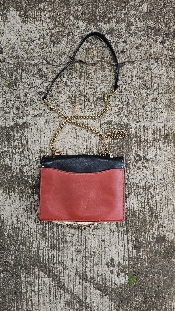 Coach Clutch with Chain Strap (Category: Luxury Bags & Wallets) located in Kibawe. Submitted by Thrift_ni_Babac (Listing ID 1434660390, Image 2). Description: - Authentic Coach clutch - Black exterior with gold-tone studs - Chain strap included - Interior with multiple compartments - Brown lining - Zipper closure - Made in Vietnam - Coach logo visible See last two photo for issue.