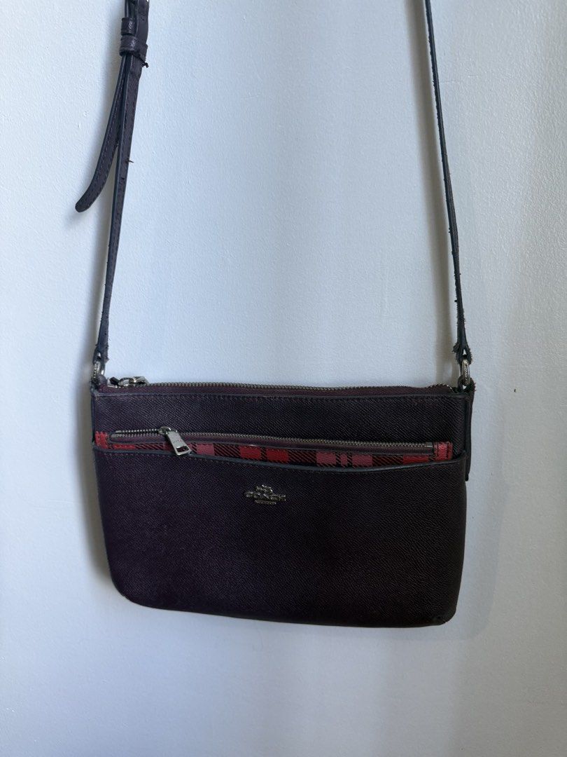 Coach Crossbody Bag with Plaid Interior (Category: Luxury Bags & Wallets) located in Makati City. Submitted by prelovedbydrjen (Listing ID 1434632276, Image 3). Description: - Authentic Coach crossbody bag - Deep burgundy exterior - Stylish plaid interior - Multiple zippered compartments for organization - Long strap for shoulder or crossbody wear - Features the Coach logo - Crafted from textured leather.