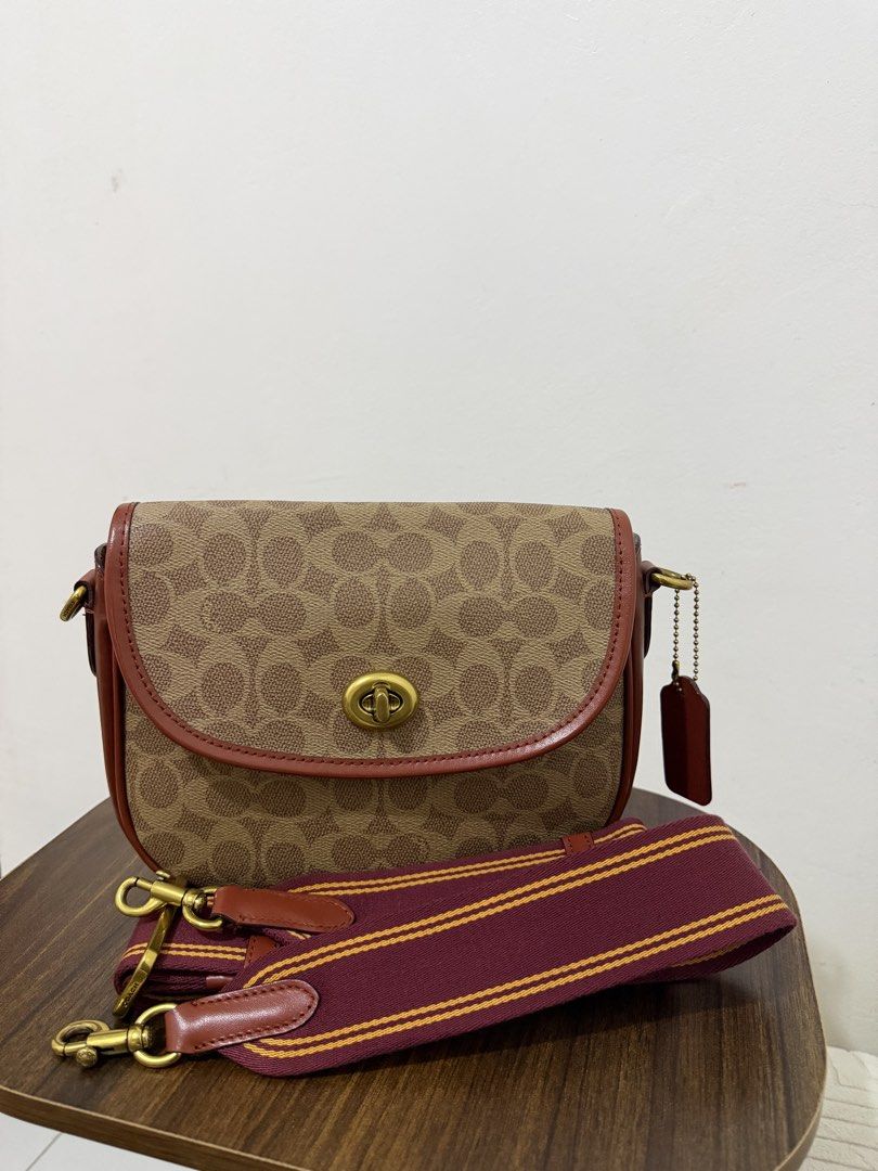 Coach Signature Crossbody Bag (Category: Luxury Bags & Wallets) located in Dasmarinas. Submitted by lovekayeeeee (Listing ID 1434705120, Image 1). Description: Coach crossbody bag with signature pattern. Features a top flap with a clasp closure. Includes a detachable striped shoulder strap and a leather tag. The interior has a zippered pocket. The bag has brown leather trim and gold-tone hardware..
