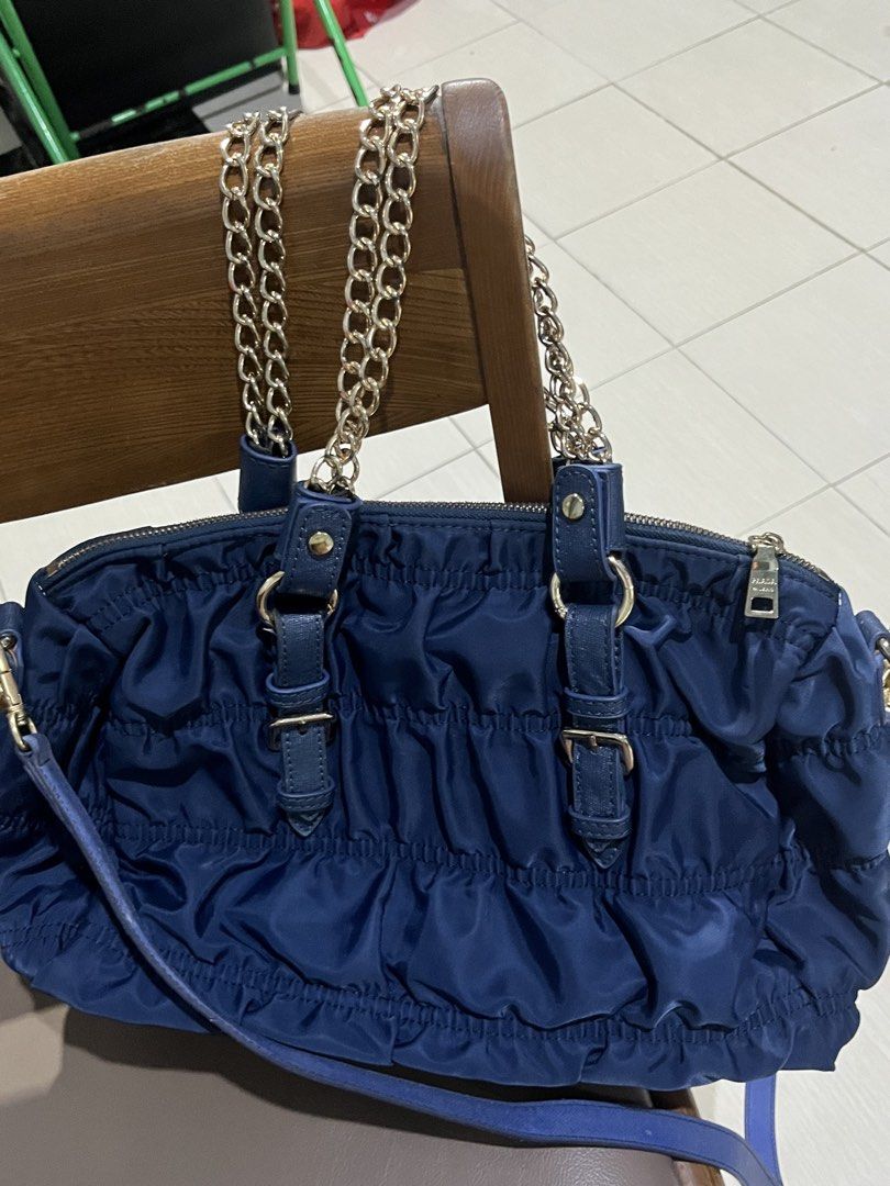 COD Available- Prada Navy Blue Handbag with Chain Strap (Category: Luxury Bags & Wallets) located in Manila. Submitted by mommaheidz (Listing ID 1419906246, Image 3). Description: - Prada handbag in navy blue - Features a stylish ruched design - Includes a chic chain strap - Silver-tone hardware - Durable nylon material - Secure zip closure - Convenient top handles - Iconic Prada logo.