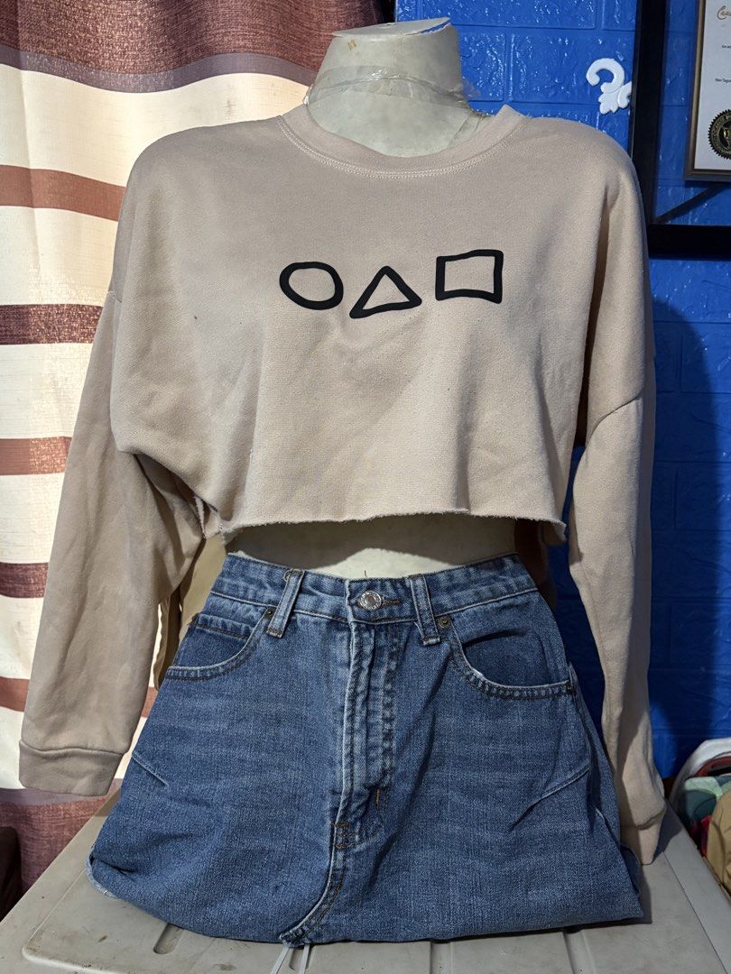 Crop Top Pull Over - All for 100 (Category: Others Tops) located in Quezon City. Submitted by ddpreloveditems (Listing ID 1434804411, Image 3). Description: - Crop top pullovers - Colors: Beige, pink, orange, black - Designs: Squid Game symbol, smiley face - Price: 100 pesos - Perfect for casual wear.