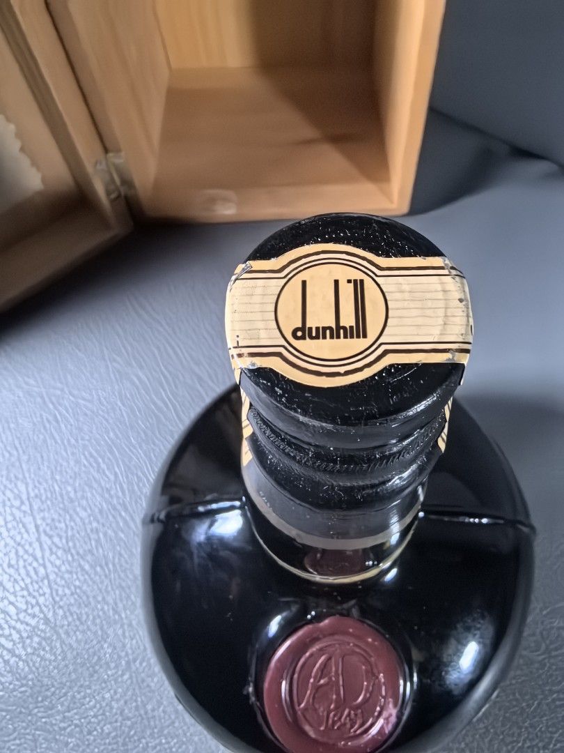 Dunhill Old Master Finest Scotch Whisky (Category: Beverages) located in Cagayan de Oro. Submitted by pootx (Listing ID 1434749504, Image 3). Description: - Vintage Dunhill Old Master Finest Scotch Whisky - Original wooden box with gold trim and Dunhill logo - Distinctive black bottle design with Dunhill label - Includes original paper insert - Cellar Master's Number: M 29012.