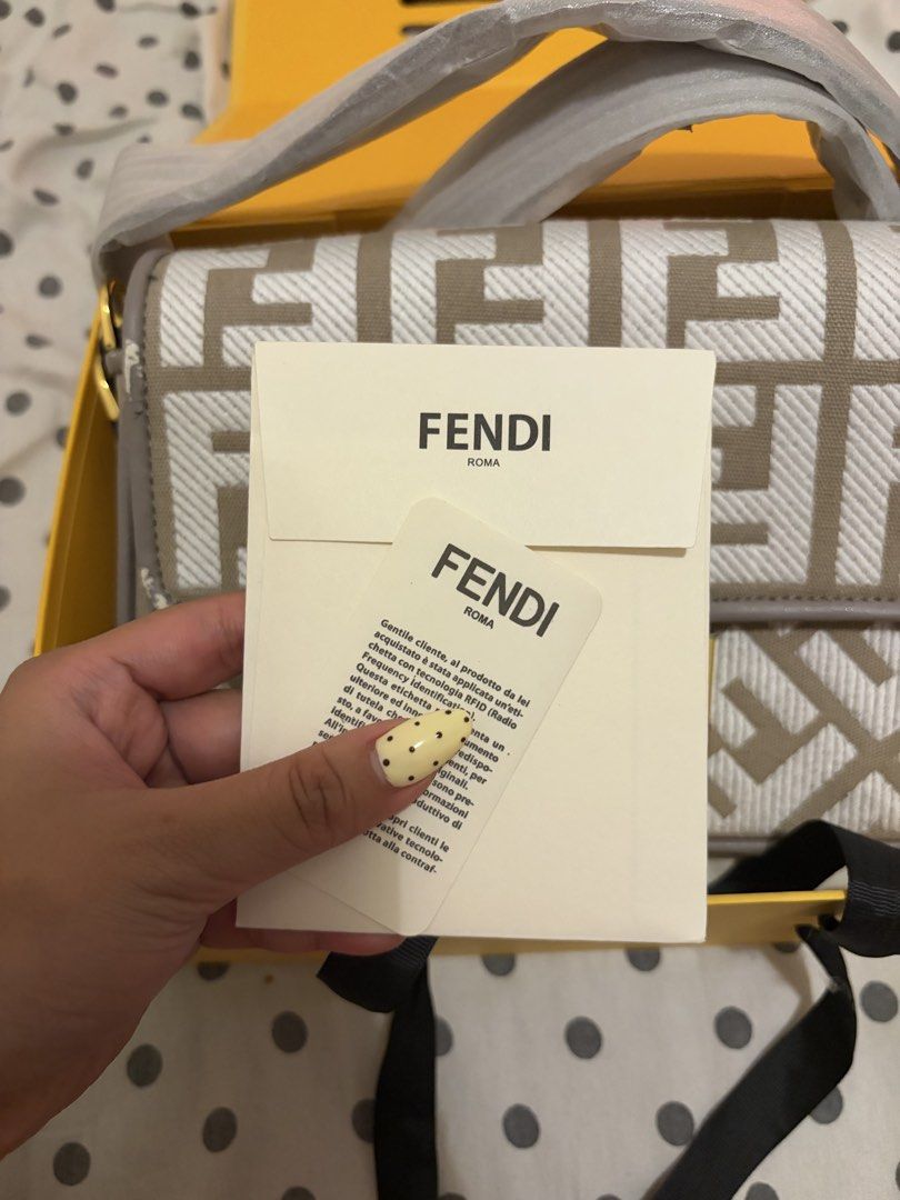 Fendi Baguette Bag (Category: Luxury Bags & Wallets) located in Quezon City. Submitted by michaella.r (Listing ID 1434784623, Image 3). Description: - Authentic Fendi Baguette bag - Iconic beige and white FF logo pattern - Includes original box, dust bag, and authenticity cards - Features a shoulder strap - Gold-tone buckle closure - Clean and well-maintained interior - Minor wear visible on the side.