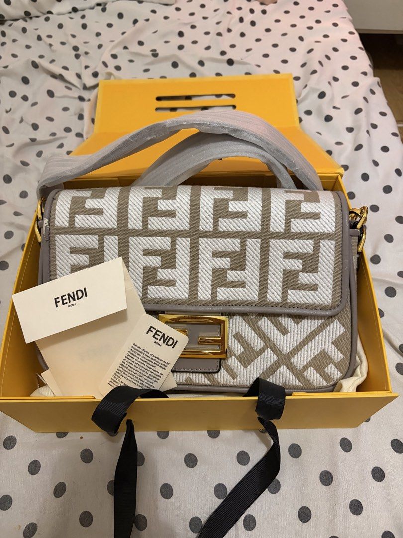Fendi Baguette Bag (Category: Luxury Bags & Wallets) located in Quezon City. Submitted by michaella.r (Listing ID 1434784623, Image 1). Description: - Authentic Fendi Baguette bag - Iconic beige and white FF logo pattern - Includes original box, dust bag, and authenticity cards - Features a shoulder strap - Gold-tone buckle closure - Clean and well-maintained interior - Minor wear visible on the side.
