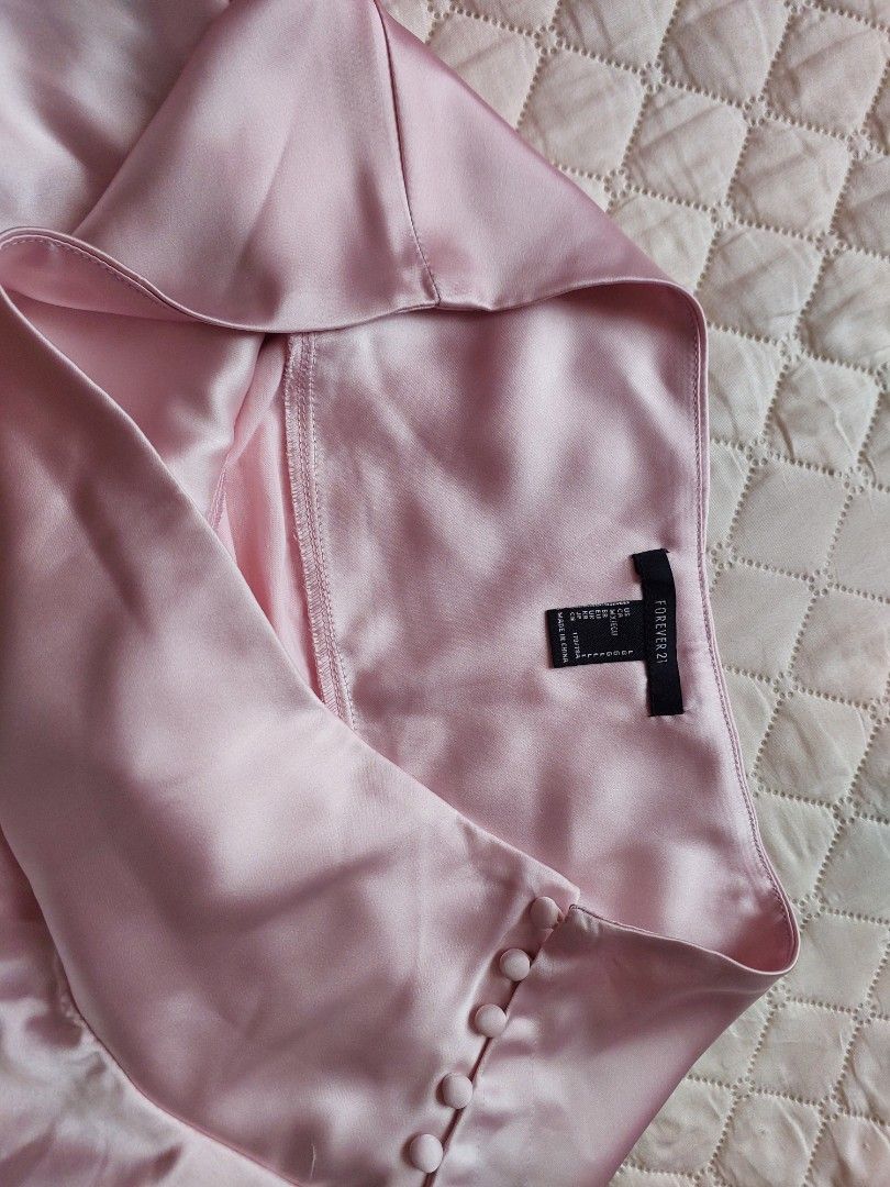Forever 21 Pink Satin Skirt (Category: Skirts) located in Cainta. Submitted by q_preloved_items (Listing ID 1434634088, Image 3). Description: - Forever 21 pink satin wrap skirt - Features button details - Includes a built-in bodysuit - Ruffled hemline - Waist: Approximately 14 inches across - never used, nalabhan lang at naalis na ang tag - super nice at nakaka sexy but this ia not style anymore. .