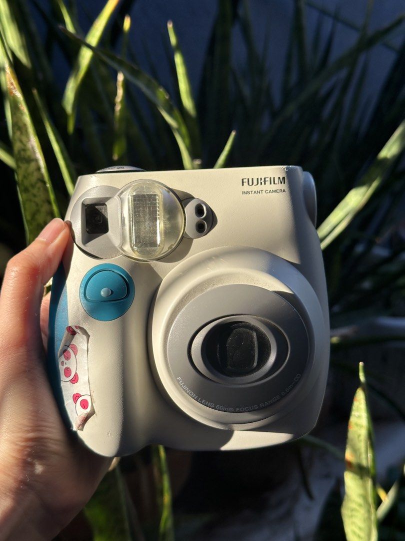 Fujifilm Instax Mini 7s (Category: Cameras) located in Angono. Submitted by beamthings (Listing ID 1434701028, Image 1). Description: Fujifilm Instax Mini 7s The OG ! Still functional, only the side cover for battery slips off so I put washi tape. Just needs film but everything still works including flash !.