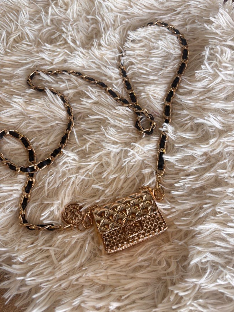 Gold Chain Bag with Black Leather (Category: Luxury Bags & Wallets) located in Cebu City. Submitted by day.98 (Listing ID 1434647824, Image 1). Description: - Elegant gold chain bag - Black leather accents - Small, quilted gold purse - Includes a coin charm - Gold chain with leather woven detailing - Adds a touch of luxury.