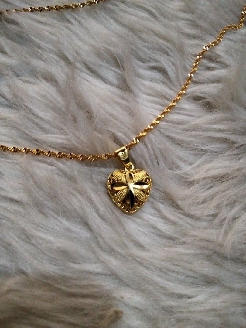 Gold Plated Heart Pendant Necklace (Category: Necklaces) located in Manila. Submitted by leapmoonlight (Listing ID 1434670939, Image 2). Description: - Gold heart pendant necklace - Features a detailed heart-shaped pendant - Delicate, twisted chain - Secure clasp - Suitable for special occasions or everyday wear.
