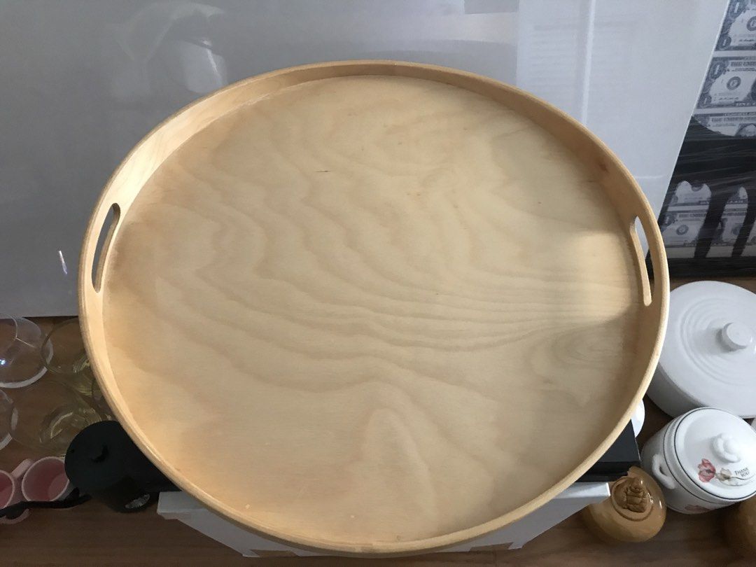 IKEA Round Serving Tray (Category: Other Kitchenware & Tableware) located in Quezon City. Submitted by draxxfinds (Listing ID 1434698765, Image 1). Description: - IKEA round serving tray - Light wood finish - Features two handles - Raised edge to prevent spills - Ideal for serving food and drinks - Can be used as a decorative piece.