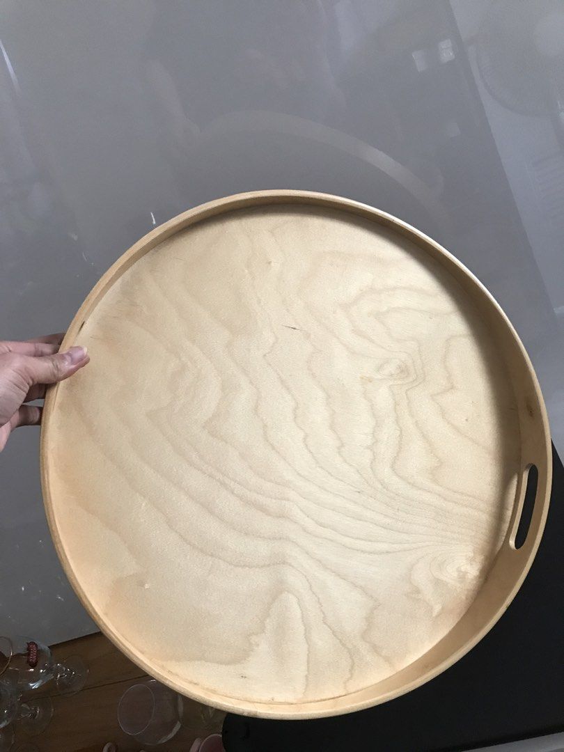 IKEA Round Serving Tray (Category: Other Kitchenware & Tableware) located in Quezon City. Submitted by draxxfinds (Listing ID 1434698765, Image 2). Description: - IKEA round serving tray - Light wood finish - Features two handles - Raised edge to prevent spills - Ideal for serving food and drinks - Can be used as a decorative piece.