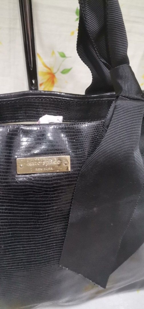 KATE SPADE BLACK Bow Top Handle Handbag (Category: Luxury Bags & Wallets) located in Baguio. Submitted by blossombeauty.chicfinds23 (Listing ID 1434675897, Image 3). Description: - Black Kate Spade handbag - Bow detail - Textured exterior - Polka dot interior lining - Interior zippered pocket - Top handle design - Rectangular shape - Metal feet at the bottom.