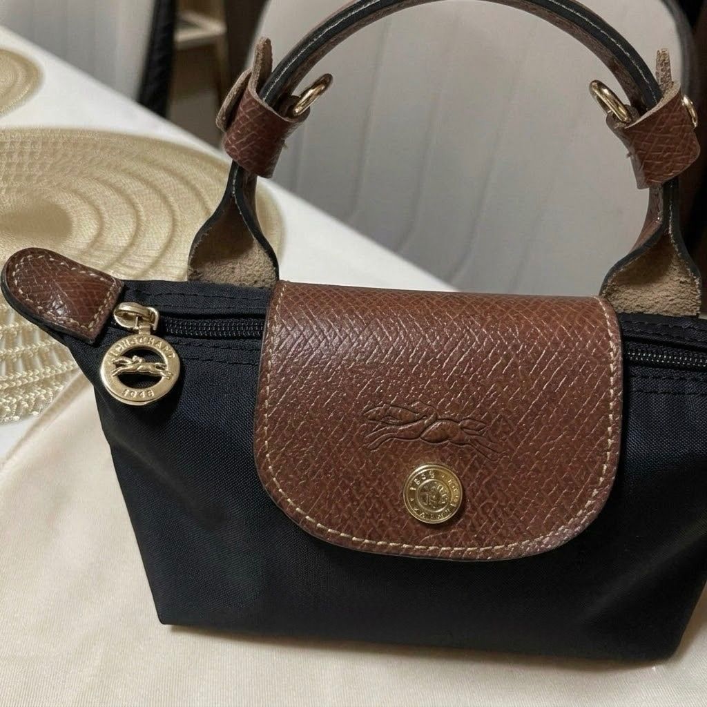 Longchamp le pliage mini sling coach crossbody bag (Category: Cross-body Bags) located in Subic. Submitted by poochieooo (Listing ID 1433864355, Image 2). Description: Preloved but in good condition Used twice Top tier quality from HK NGA!!! Price is such a steal!! Pls manage your expectations this is preloved/used (For sure buyers only) 🫶🏻.