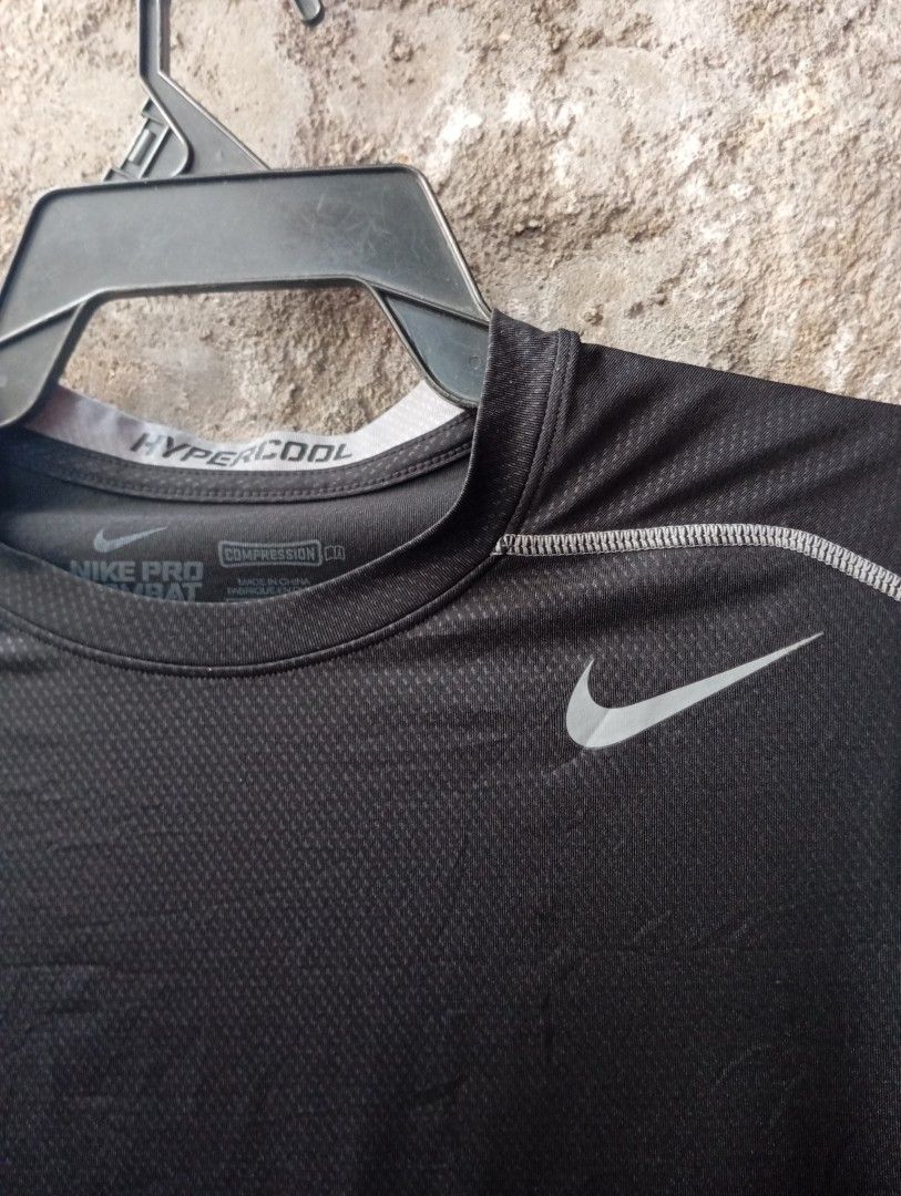 Nike Pro Combat Hypercool Compression Shirt (Category: Activewear) located in Manila. Submitted by pandahustlers (Listing ID 1434689944, Image 2). Description: - Nike Pro Combat Hypercool compression shirt - Black and gray color scheme - White stitching details - Nike logo on chest - Mesh panel on back - Size: L - Made in Indonesia.