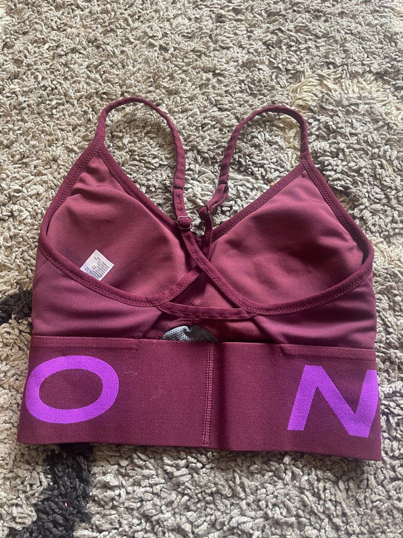 Nike Pro Sports Bra (Category: Activewear) located in La Trinidad. Submitted by avessonjam (Listing ID 1434716714, Image 3). Description: - Nike Pro sports bra - Burgundy color with purple "NIKE PRO" band - Racerback design - Thin straps - Nike logo on front - Made of stretchy material.
