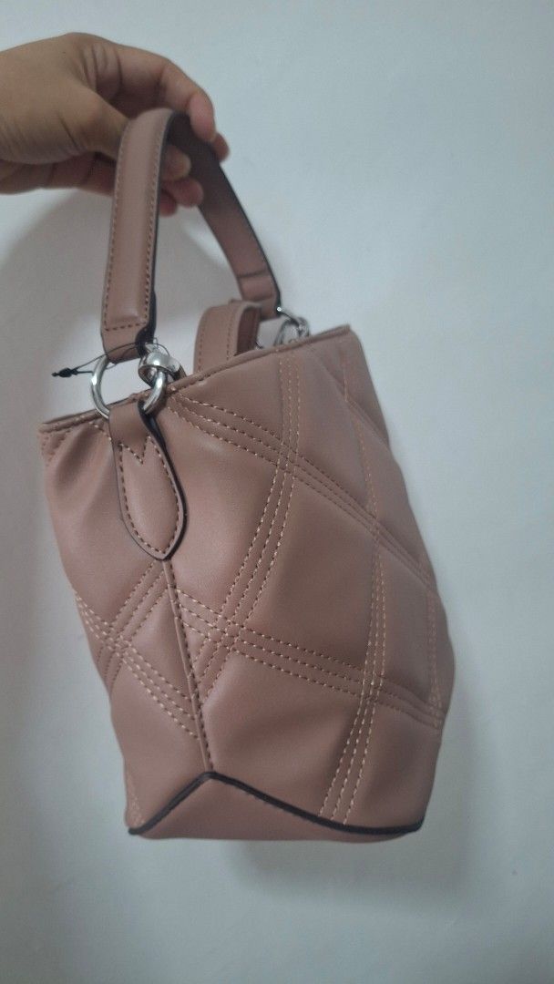 Nine West Quilted Handbag with Chain Strap (Category: Luxury Bags & Wallets) located in Quezon City. Submitted by _helpmedeclutter (Listing ID 1434610252, Image 3). Description: 21x21cm - Nine West handbag - Dusty rose color - Quilted design - Top handle - Detachable chain strap (shoulder/crossbody) - Magnetic closure - Small interior pocket - Brand new with tag.