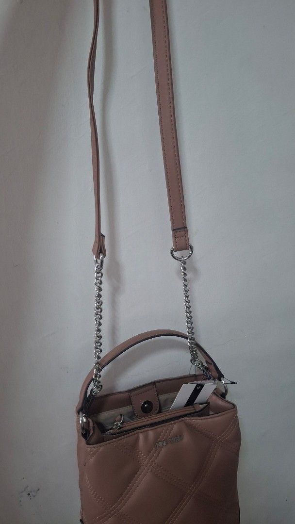 Nine West Quilted Handbag with Chain Strap (Category: Luxury Bags & Wallets) located in Quezon City. Submitted by _helpmedeclutter (Listing ID 1434610252, Image 2). Description: 21x21cm - Nine West handbag - Dusty rose color - Quilted design - Top handle - Detachable chain strap (shoulder/crossbody) - Magnetic closure - Small interior pocket - Brand new with tag.
